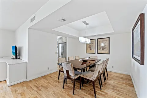 a view of a dining room with furniture and wooden floor
