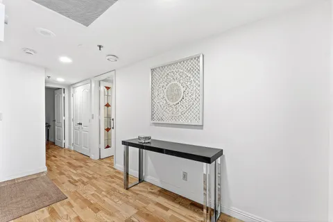 a view of a hallway with paintings on the wall