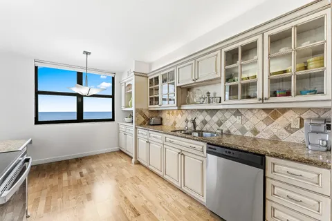 a kitchen with granite countertop a sink and cabinets