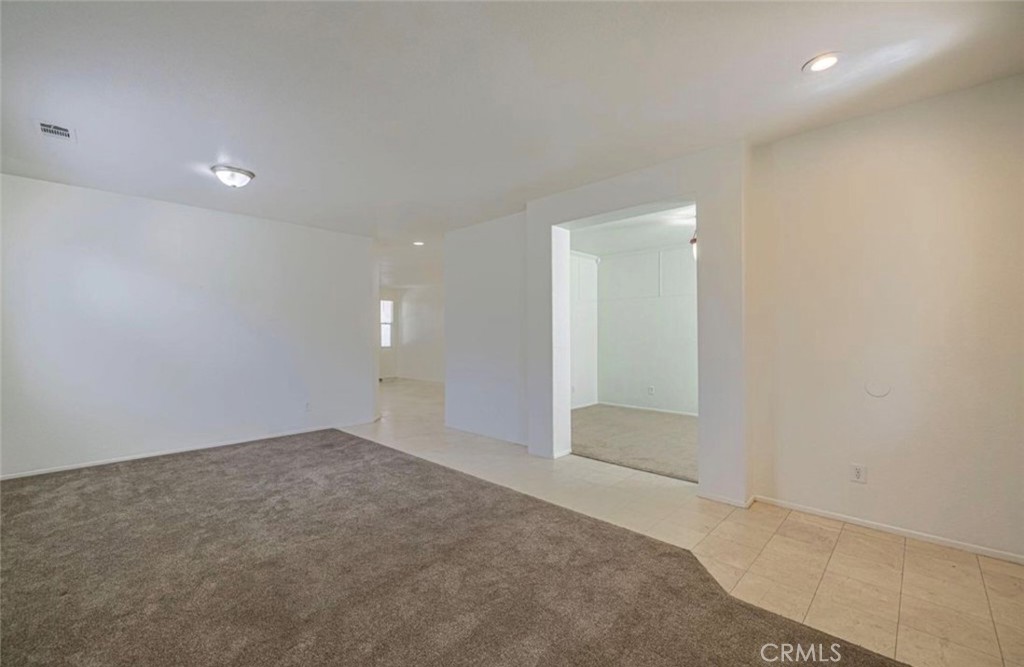43839 58th Street West Lancaster, CA 93536 - Photo 5 of 18 an empty room with an entryway