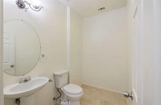a bathroom with a sink mirror and toilet
