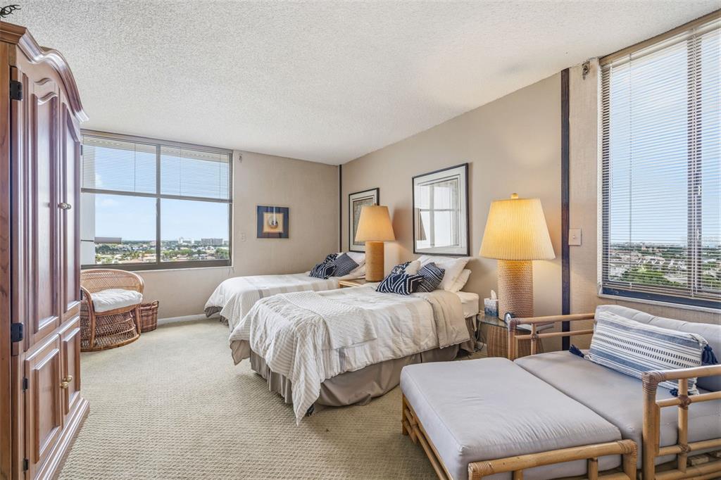 9495 Blind Pass Road, Unit 1208 St. Pete Beach, FL 33706 - Photo 19 of 62 a bed room with two beds and a large window