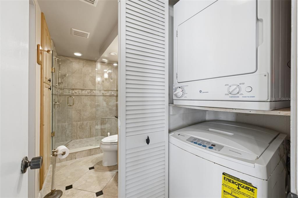 9495 Blind Pass Road, Unit 1208 St. Pete Beach, FL 33706 - Photo 23 of 62 a bathroom with a sink a toilet and shower