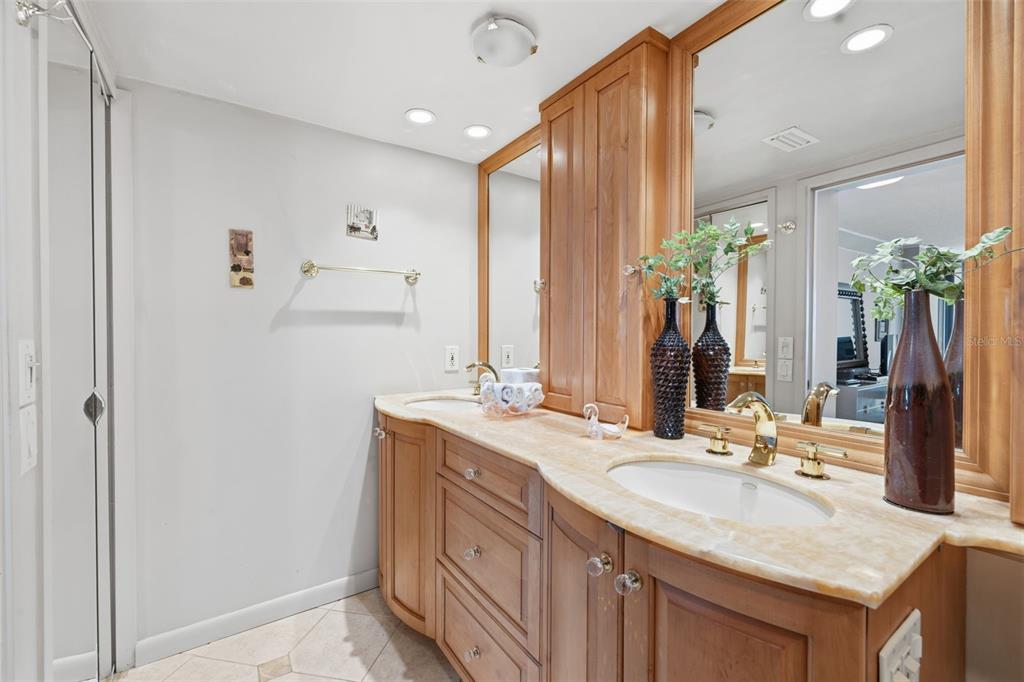 9495 Blind Pass Road, Unit 1208 St. Pete Beach, FL 33706 - Photo 28 of 61 a bathroom with a granite countertop sink and a mirror