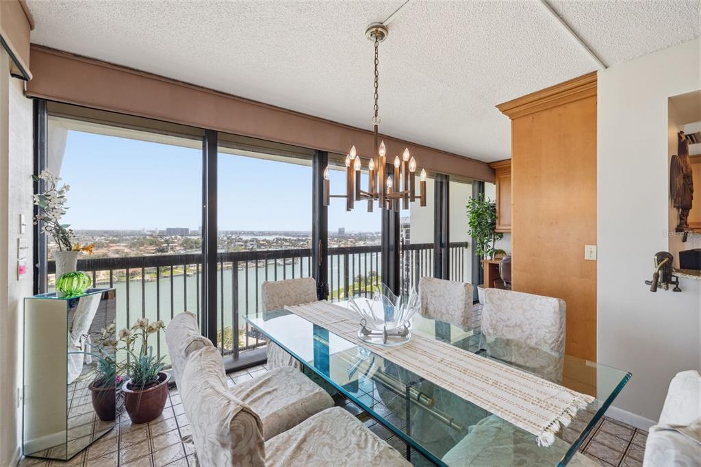 9495 Blind Pass Road, Unit 1208 St. Pete Beach, FL 33706 - Photo 6 of 61 a living room with furniture tv and a floor to ceiling window
