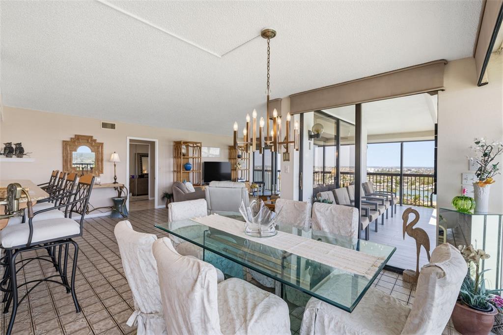 9495 Blind Pass Road, Unit 1208 St. Pete Beach, FL 33706 - Photo 7 of 61 a living room with furniture and a floor to ceiling windows