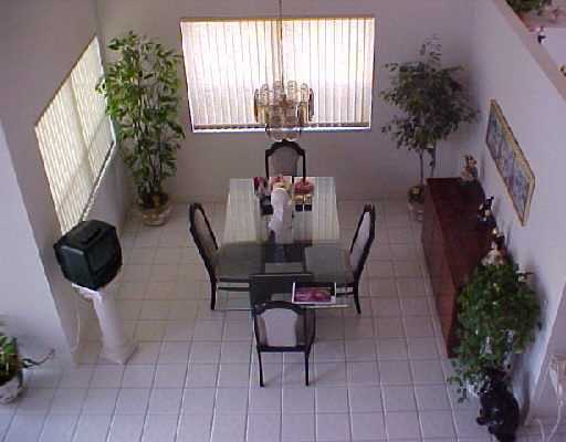 23403 Boca Trace Drive, Unit 23403 Boca Raton, FL 33433 - Photo 8 of 8 a view of a dining room with furniture and a potted plant