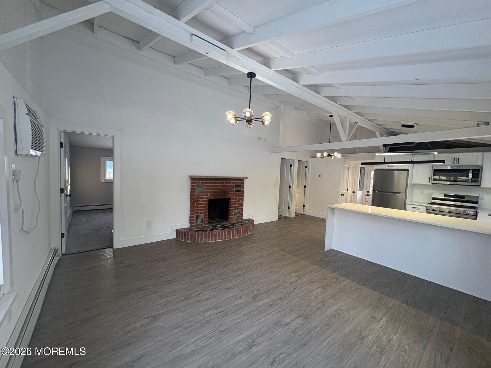 809 Pensacola Road Forked River, NJ 08731 - Photo 3 of 7 a view of a kitchen with a sink and a refrigerator