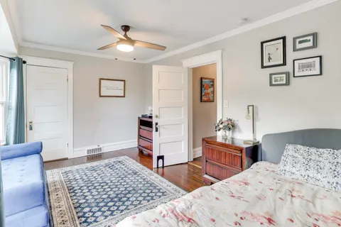a bedroom with a bed and wooden floor