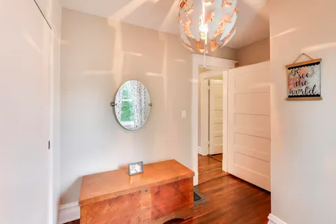 a room with a table and a chandelier