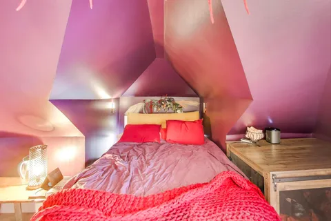 a bed room with a bed and a night stand