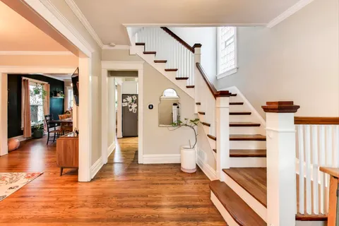 a view of entryway and hall with wooden floor