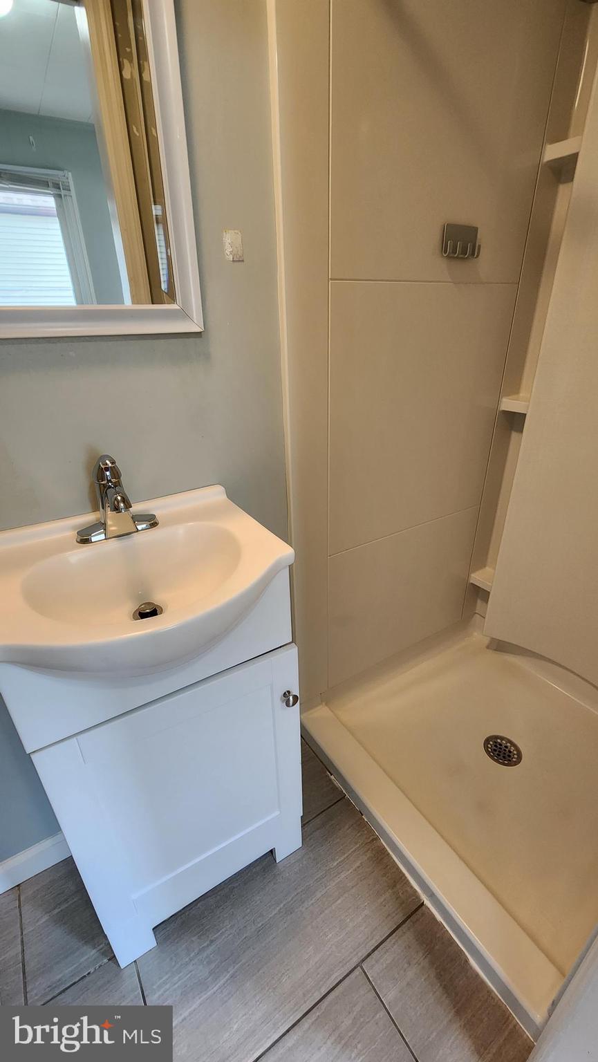 225 Deptford Road Glassboro, NJ 08028 - Photo 11 of 19 a bathroom with a tub and a sink