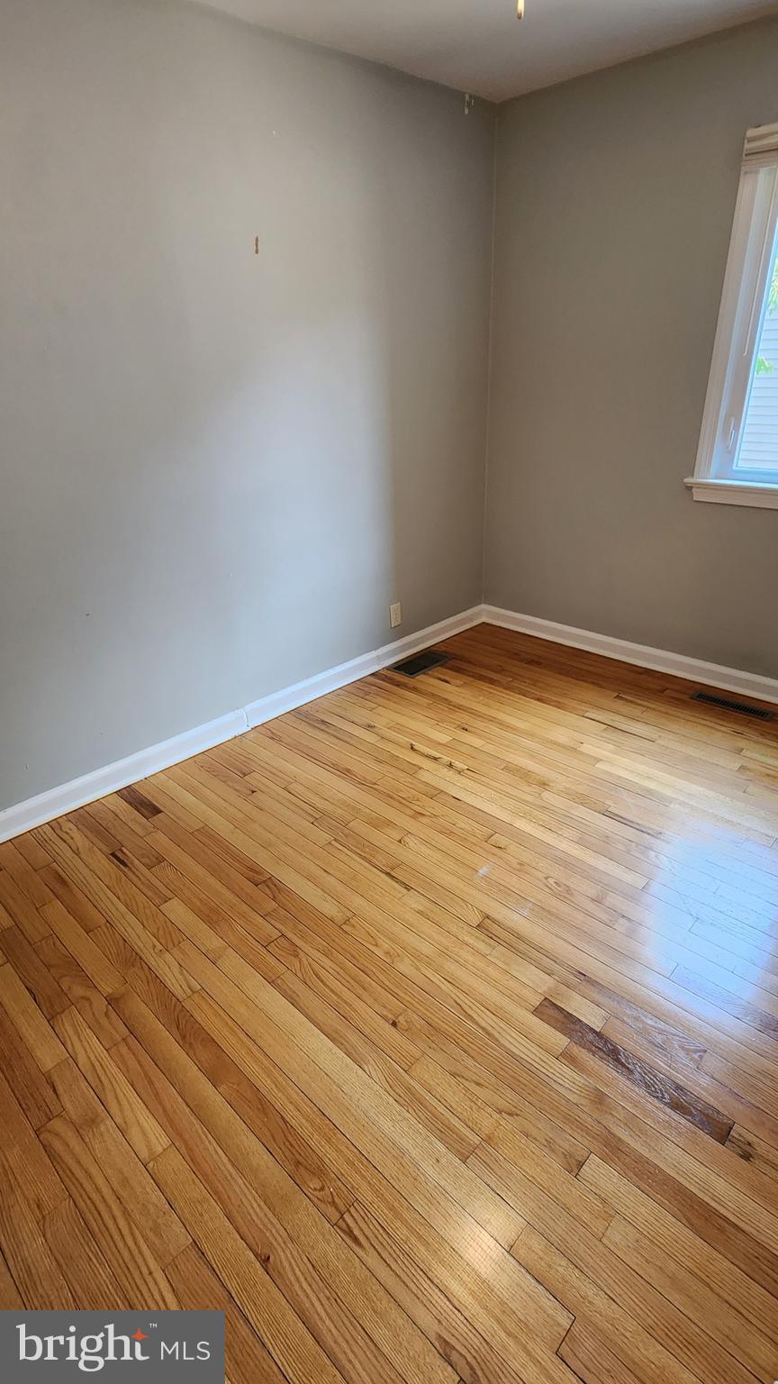 225 Deptford Road Glassboro, NJ 08028 - Photo 13 of 19 a view of empty room with wooden floor and fan