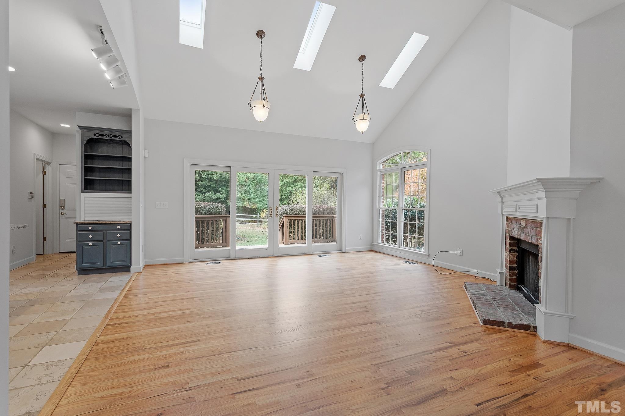 4025 Cuchalain Road Raleigh, NC 27616 - Photo 14 of 34 an empty room with windows and a fireplace