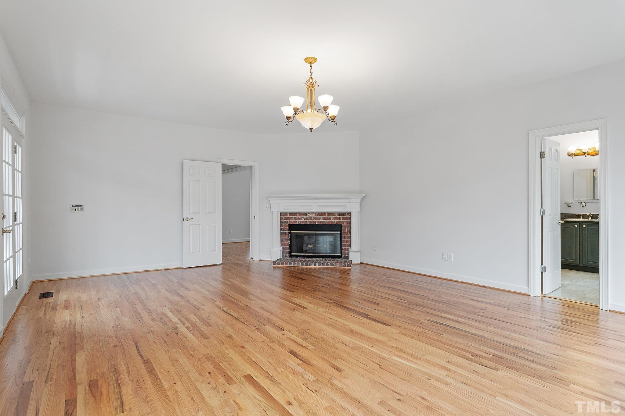 4025 Cuchalain Road Raleigh, NC 27616 - Photo 28 of 34 a view of a room with wooden floor fireplace and window