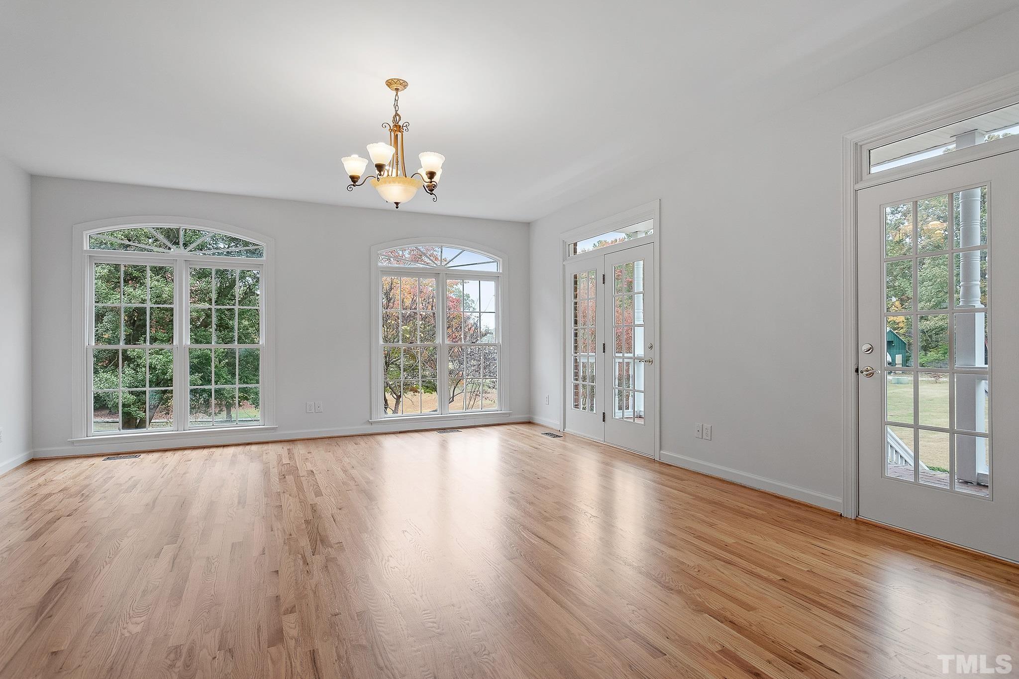 4025 Cuchalain Road Raleigh, NC 27616 - Photo 29 of 34 a view of an empty room with wooden floor and a window