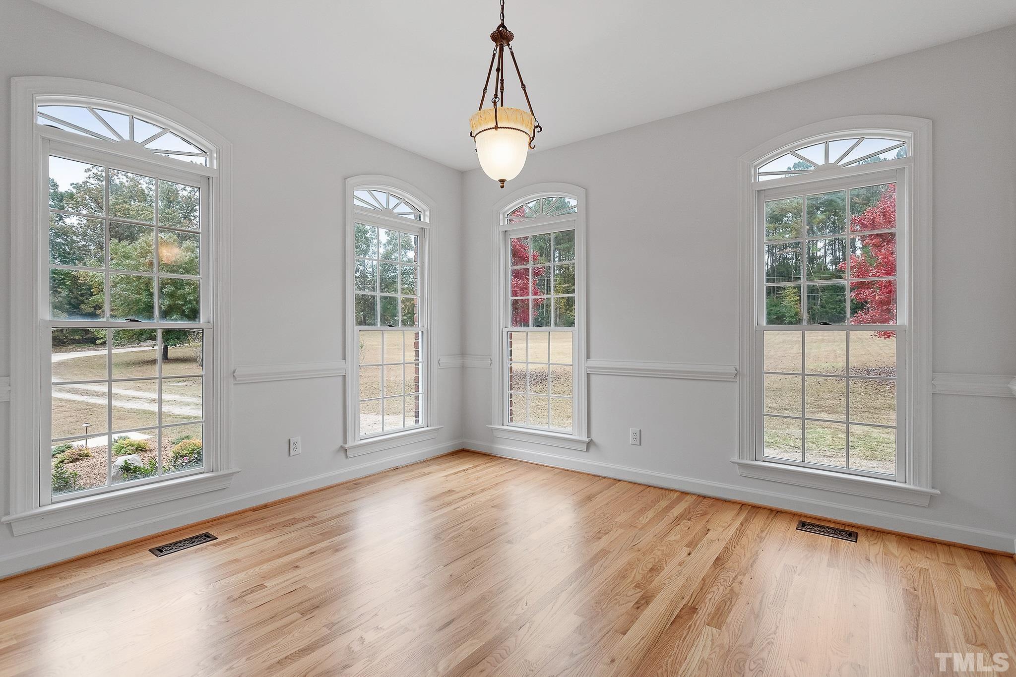 4025 Cuchalain Road Raleigh, NC 27616 - Photo 33 of 34 a view of an empty room with wooden floor and a window