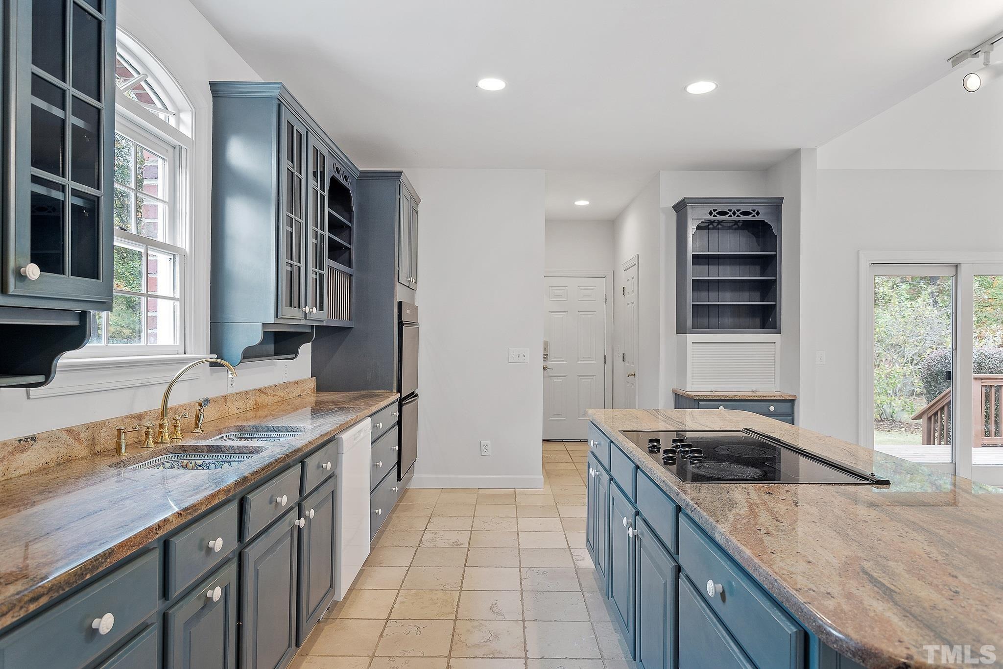 4025 Cuchalain Road Raleigh, NC 27616 - Photo 10 of 34 a kitchen with granite countertop a sink stove and cabinets