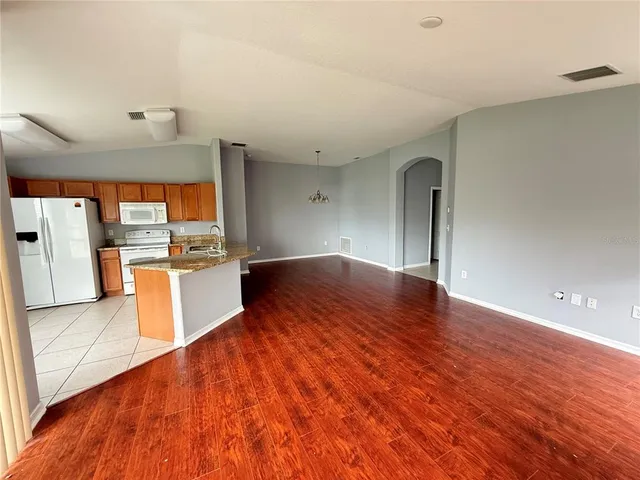 a kitchen with stainless steel appliances a refrigerator sink and microwave