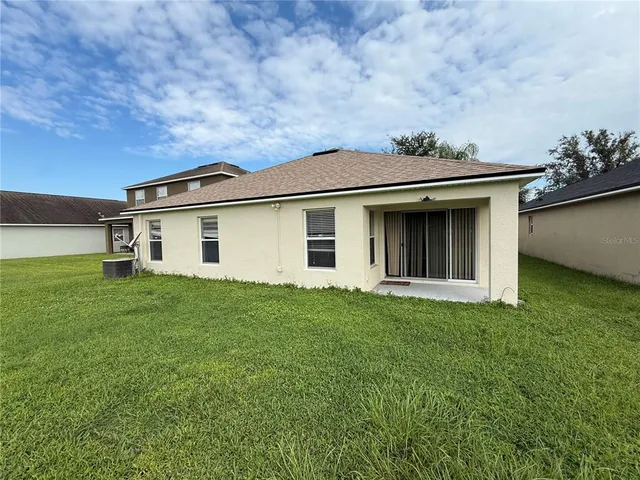 an aerial view of field and trees