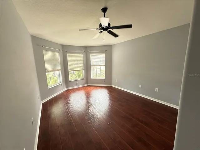 a bathroom with a granite countertop sink toilet a mirror and a tub