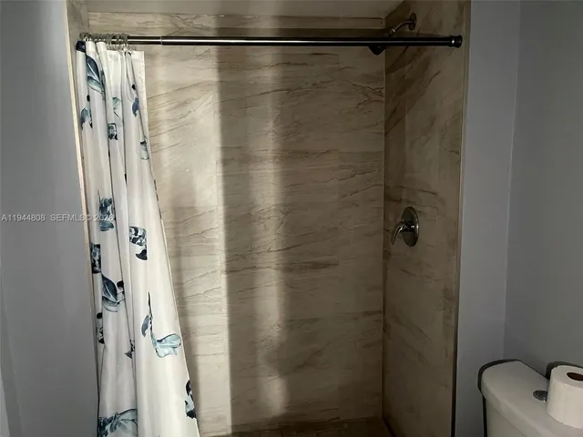 a bathroom with a shower and a shower