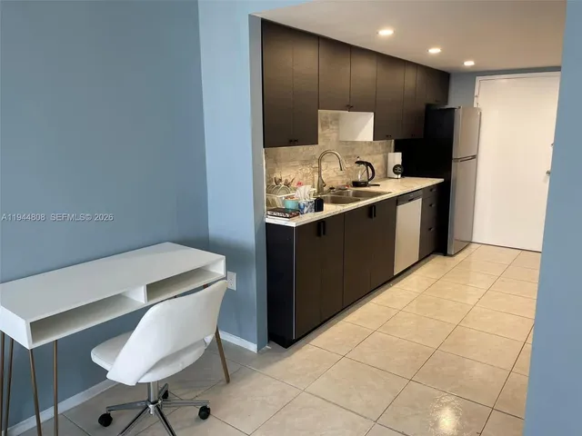 a kitchen with a sink cabinets and appliances