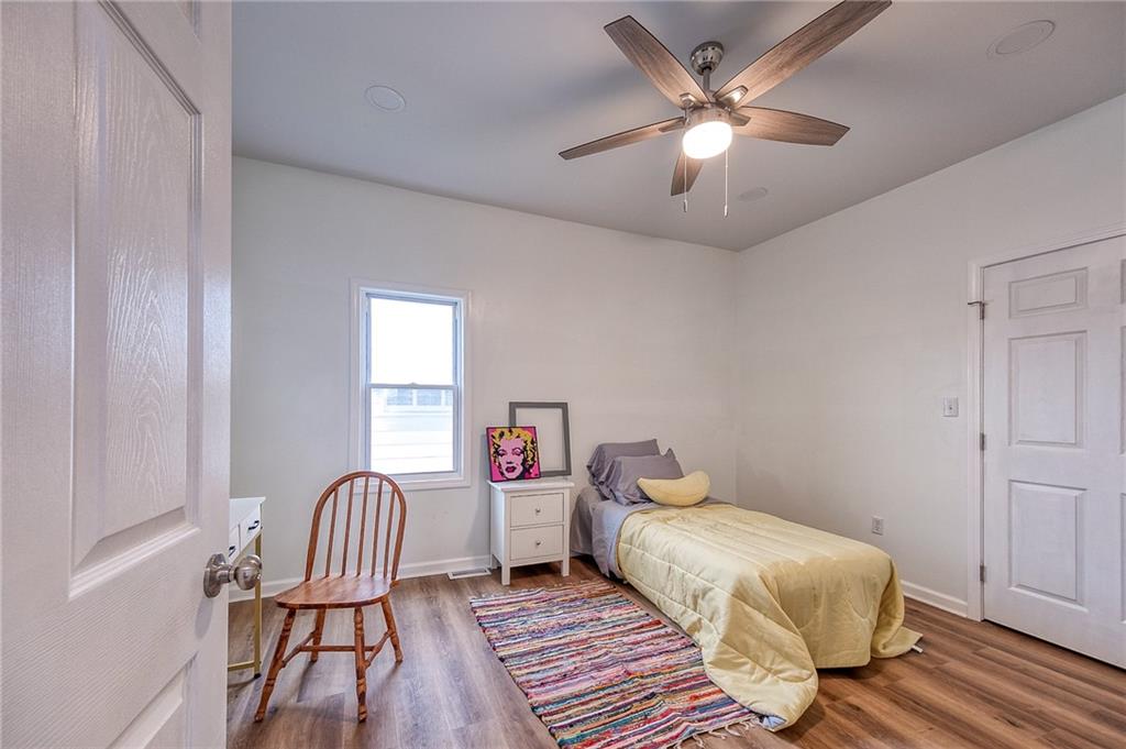 1415 Pacific Avenue Monaca, PA 15061 - Photo 11 of 39 a spacious bedroom with a bed and a chandelier