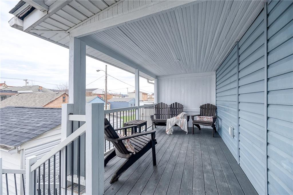 1415 Pacific Avenue Monaca, PA 15061 - Photo 14 of 39 a view of a balcony with couch and wooden floor