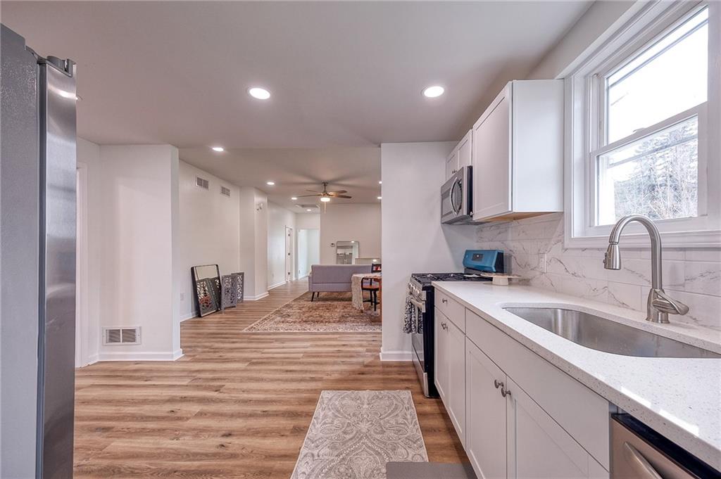 1415 Pacific Avenue Monaca, PA 15061 - Photo 26 of 39 a large kitchen with stainless steel appliances granite countertop a sink and cabinets