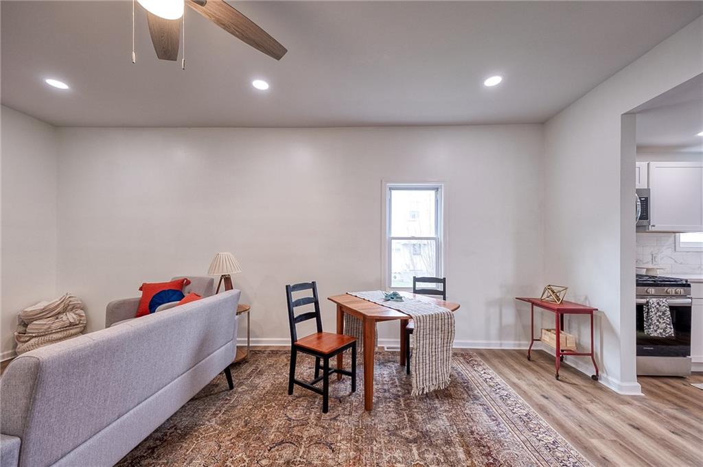 1415 Pacific Avenue Monaca, PA 15061 - Photo 27 of 39 a living room with a couch and a dining table with wooden floor
