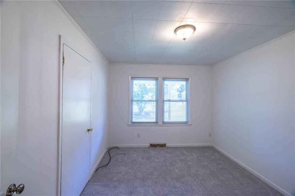 204 Pinecrest Road Madison, NC 27025 - Photo 8 of 32 Other / Office: Features include new carpet flooring to help keep your feet warm on cool days; you have 2 windows for natural lighting with blinds for privacy, fresh new paint and decorative crown molding. The closet is to the left side.