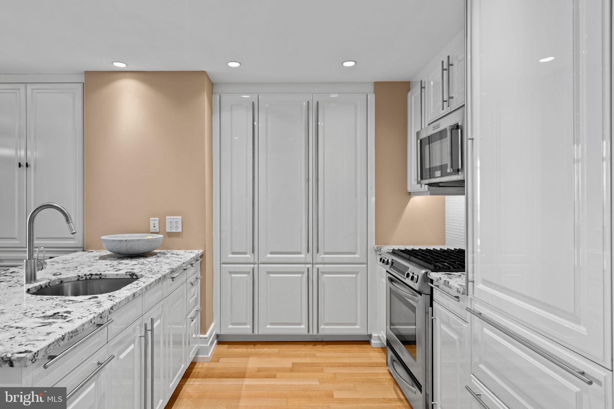 130 South 18th Street, Unit 503 Philadelphia, PA 19103 - Photo 2 of 43 a kitchen with granite countertop a sink stainless steel appliances and cabinets
