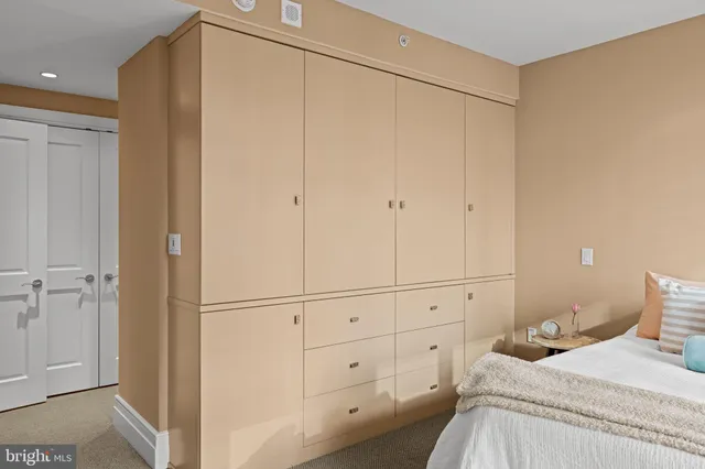 a bedroom with a bed and a cabinets