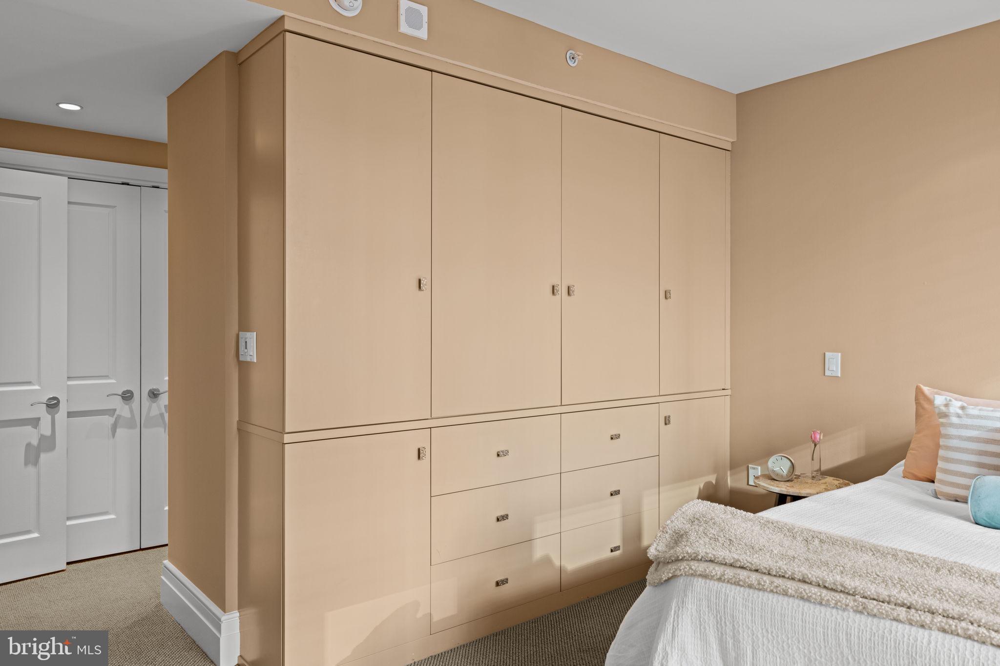 130 South 18th Street, Unit 503 Philadelphia, PA 19103 - Photo 25 of 43 a bedroom with a bed and a cabinets