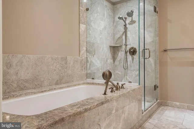 a bathroom with a bathtub and a shower