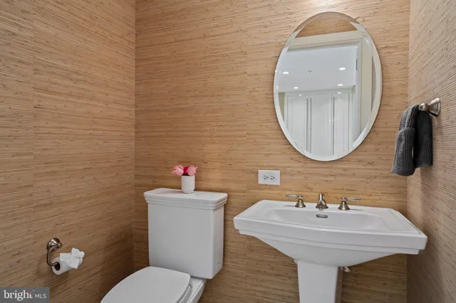 a bathroom with a sink a toilet and a mirror