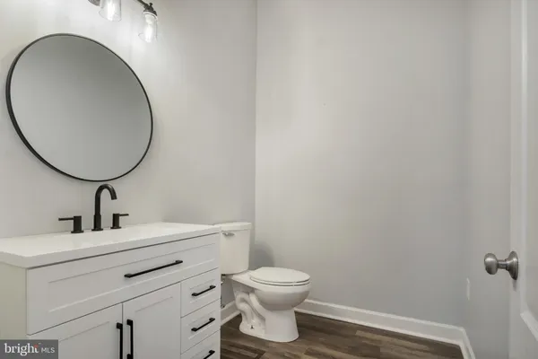 a spacious bathroom with a granite countertop sink toilet and shower