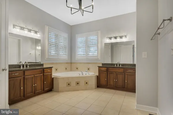a view of an empty room with wooden floor and closet