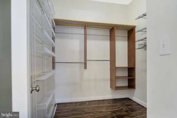 an empty room with windows and ceiling fan