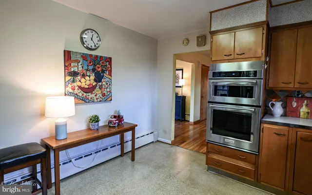 a view of a bedroom with window and wooden floor