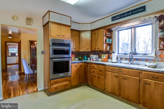 a bedroom with a bed and a dresser next to a window