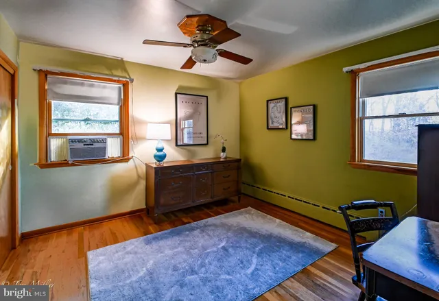 a living room with furniture a lamp and a flat screen tv