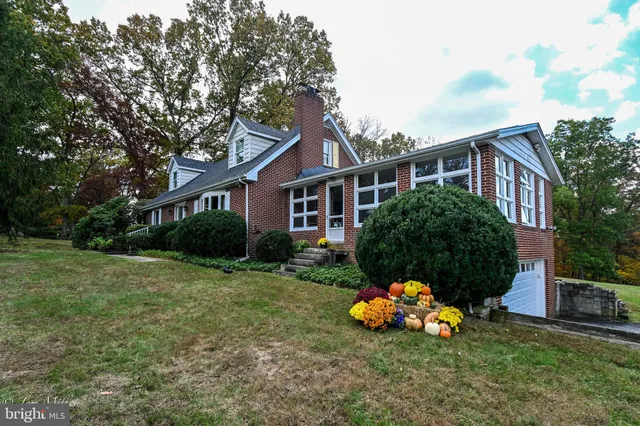 a view of a dining room with furniture a chandelier and wooden floor