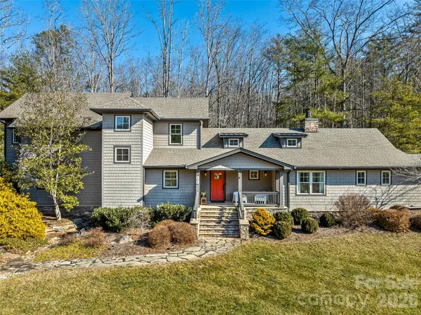 a view of a house with a yard patio and fire pit