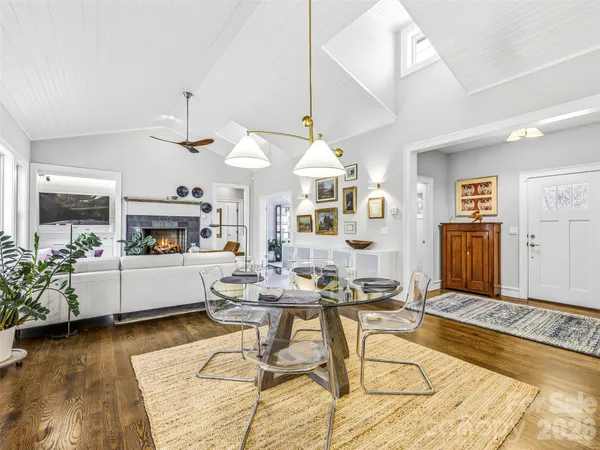 a living room with kitchen island furniture and a chandelier
