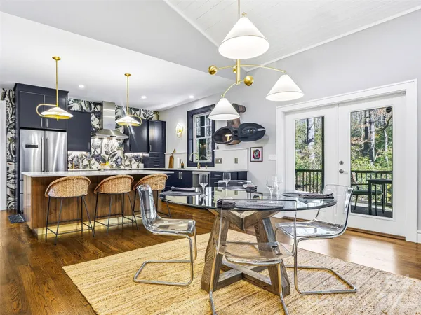 a view of a dining room with furniture wooden floor and chandelier