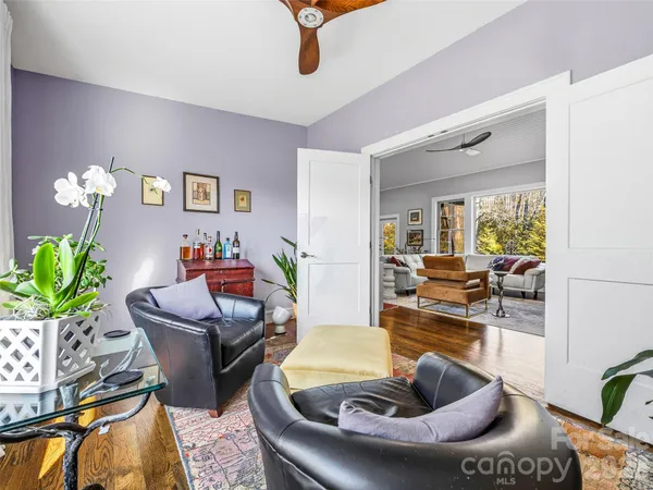 a living room with furniture and a potted plant