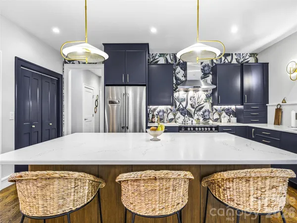 a view of a kitchen with a table and chairs